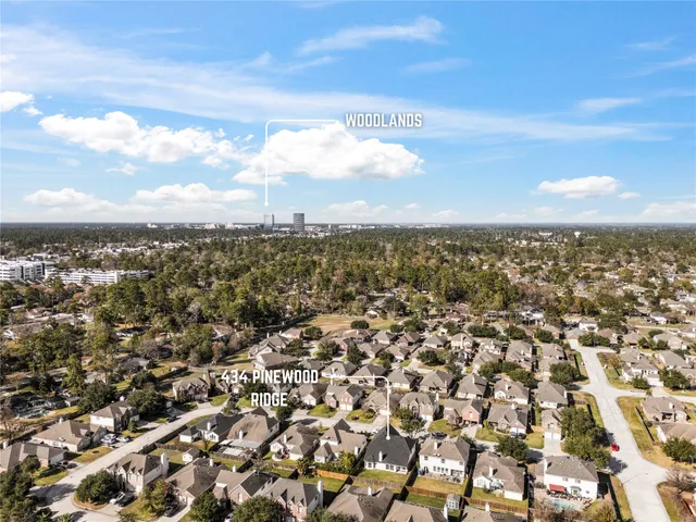 an aerial view of residential building and trees around