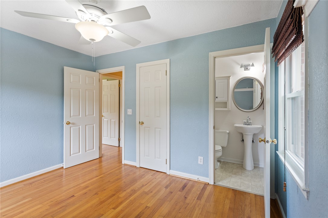 202 Keowee Trail Seneca, SC 29672 - Photo 19 of 35 This spacious room features rich hardwood flooring and a ceiling fan, with an adjoining bathroom.