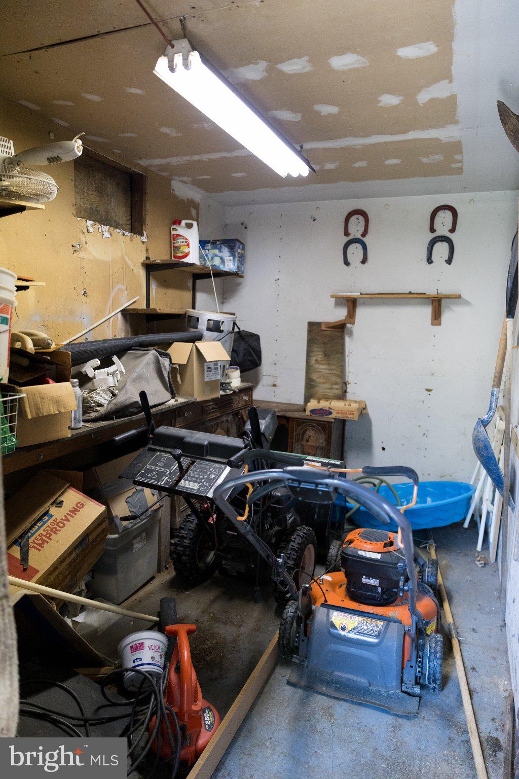 16827 Hampton Road Williamsport, MD 21795 - Photo 42 of 42 Cluttered garage with tools and storage.