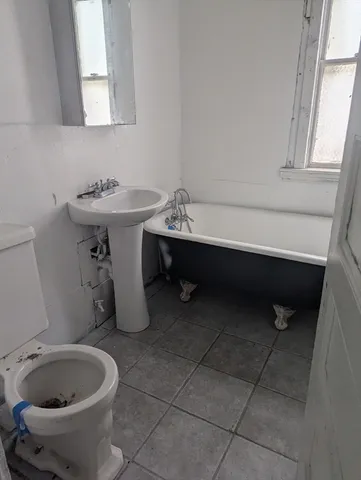 a bathroom with a sink toilet and mirror