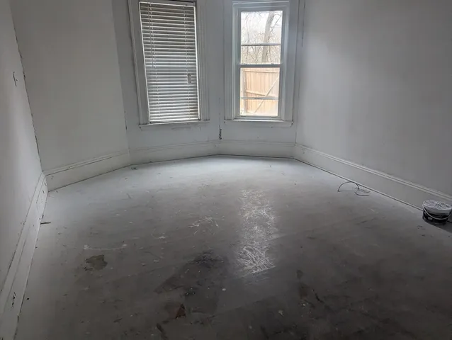 an empty room that has a window in it