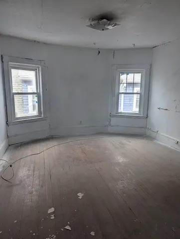 an empty room with a empty space and windows