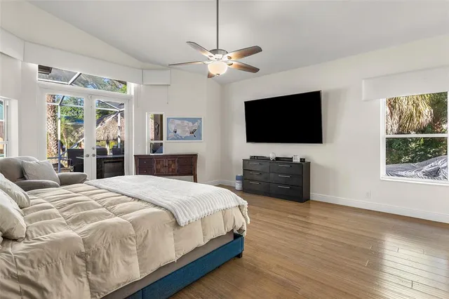 a spacious bathroom with a granite countertop sink a toilet and a large mirror
