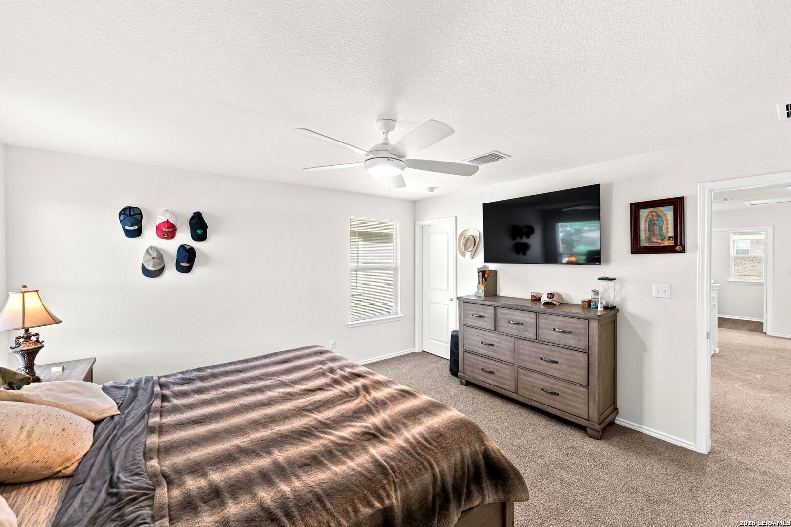 1029 Santiam Street Georgetown, TX 78626 - Photo 27 of 37 a bedroom with a bed and flat screen tv