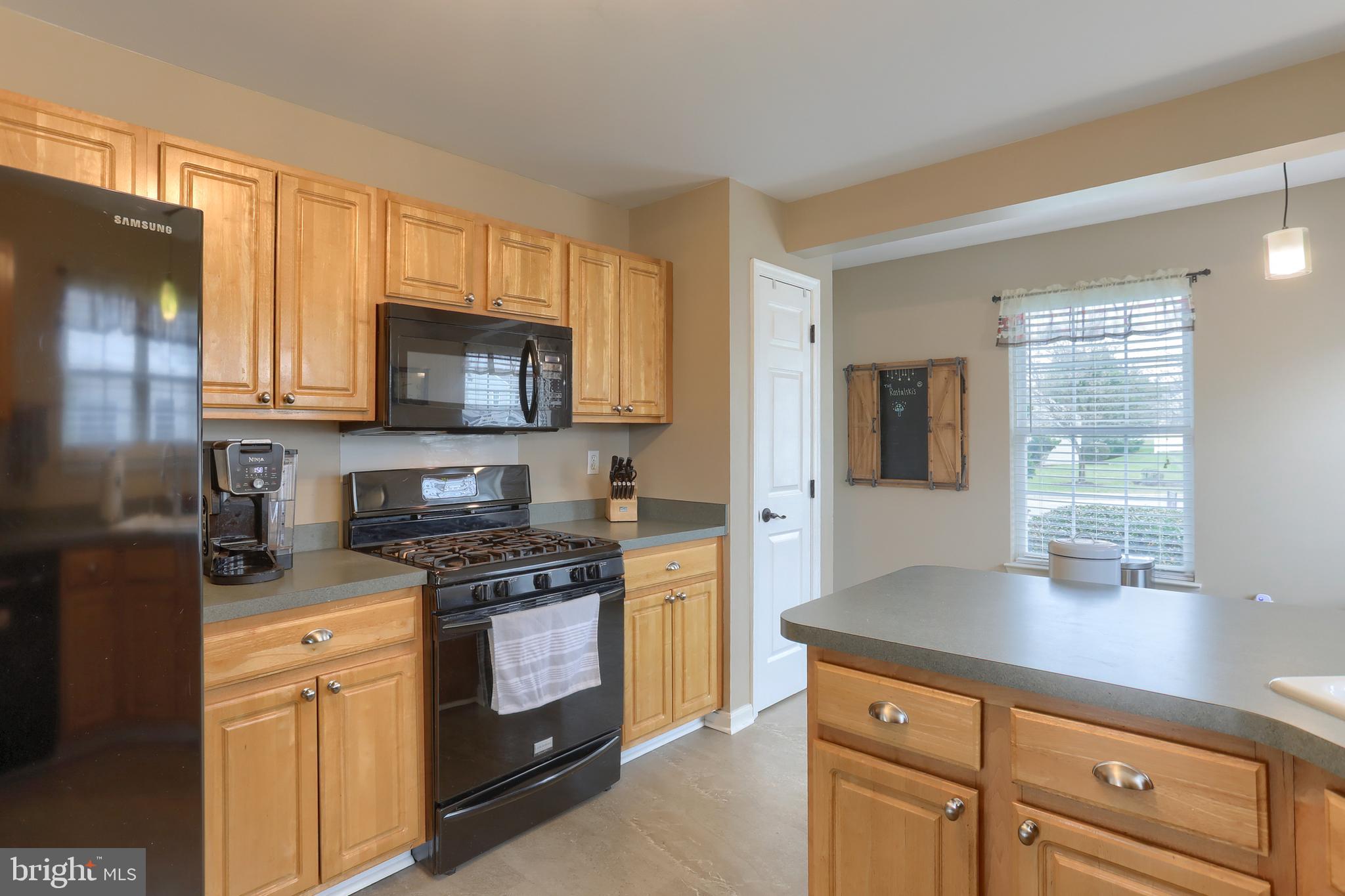 6456 Terrace Court Harrisburg, PA 17111 - Photo 15 of 39 a kitchen with a stove a sink and a microwave