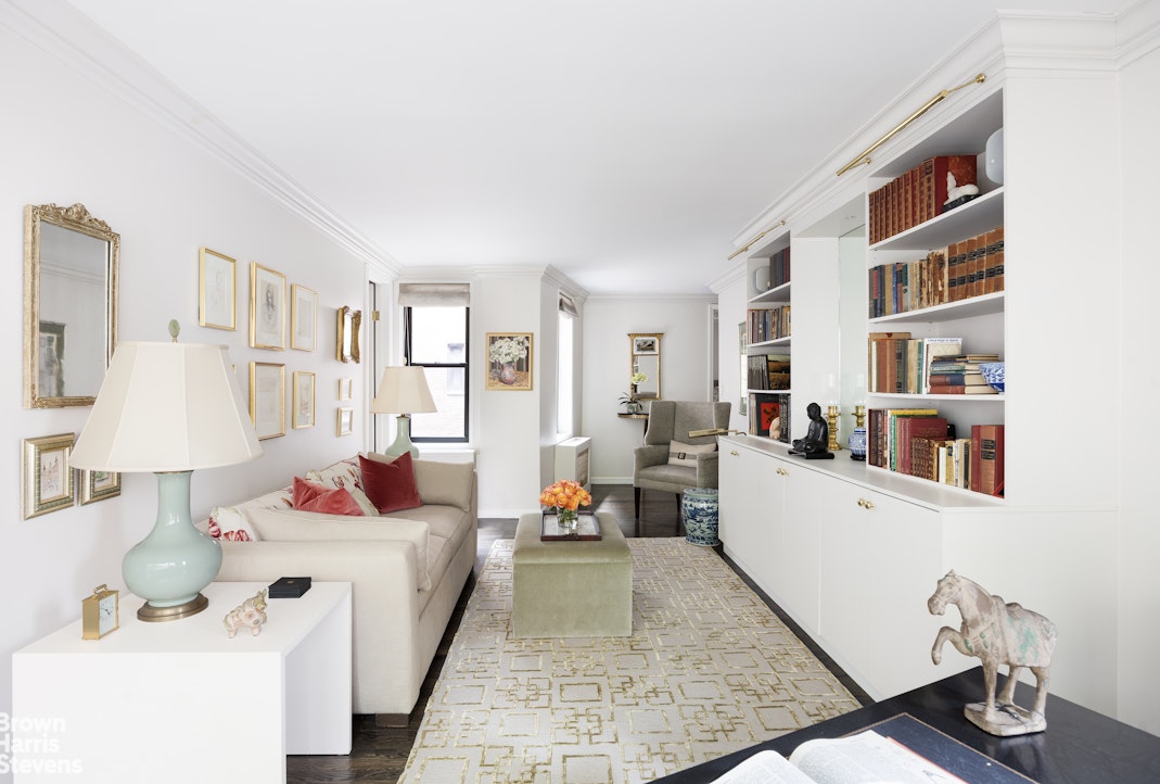 342 East 53rd Street, Unit 2GH Manhattan, NY 10022 - Photo 2 of 9 a living room with furniture and a book shelf