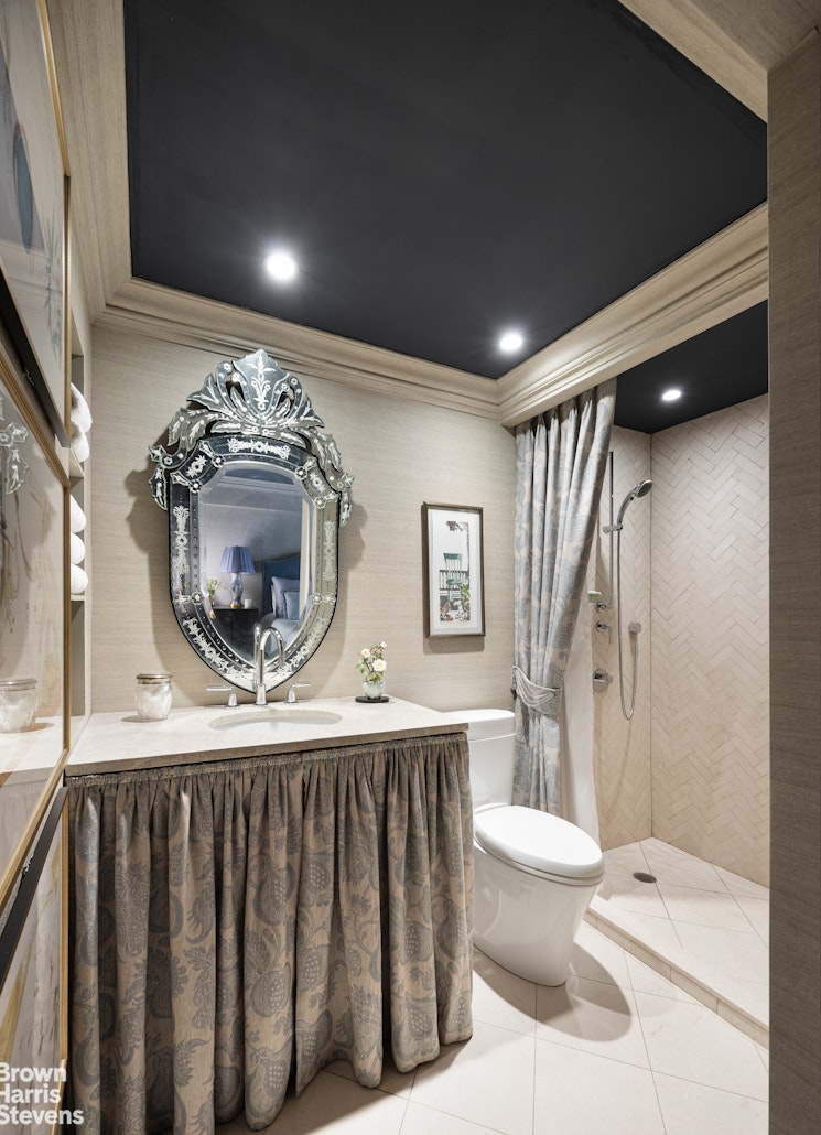 342 East 53rd Street, Unit 2GH Manhattan, NY 10022 - Photo 6 of 9 a bathroom with a toilet a sink and a mirror