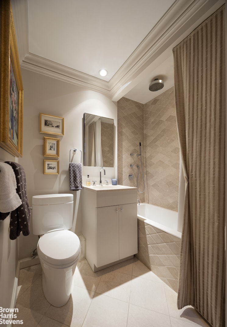 342 East 53rd Street, Unit 2GH Manhattan, NY 10022 - Photo 8 of 9 a bathroom with a toilet a sink and a bathtub