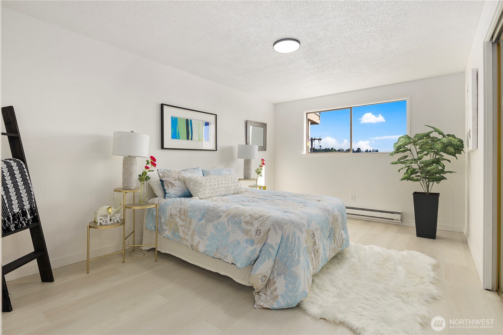 22532 6th Avenue South, Unit A2 Seattle, WA 98198 - Photo 19 of 35 a bedroom with a bed and a potted plant