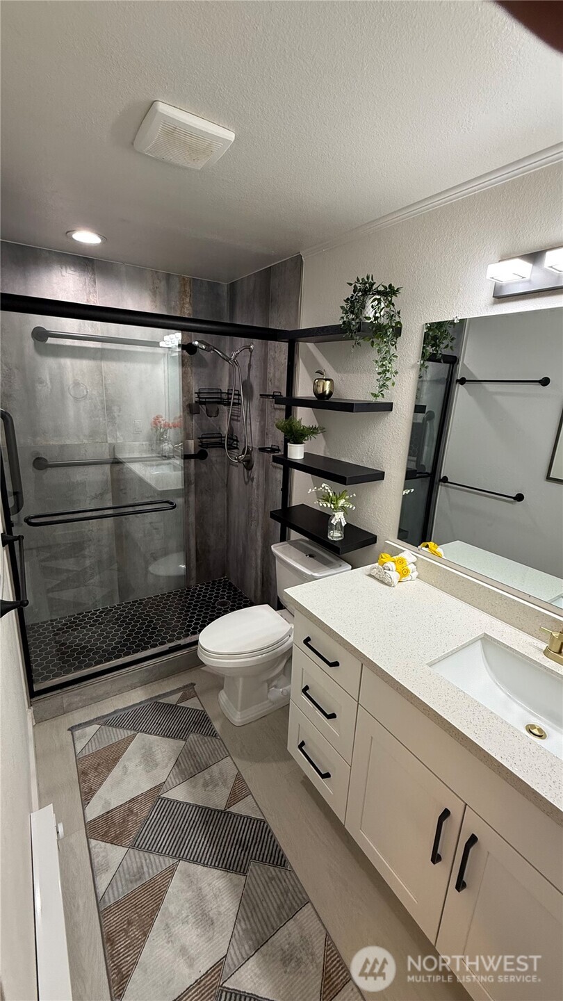 22532 6th Avenue South, Unit A2 Seattle, WA 98198 - Photo 25 of 35 a bathroom with a sink and a shower