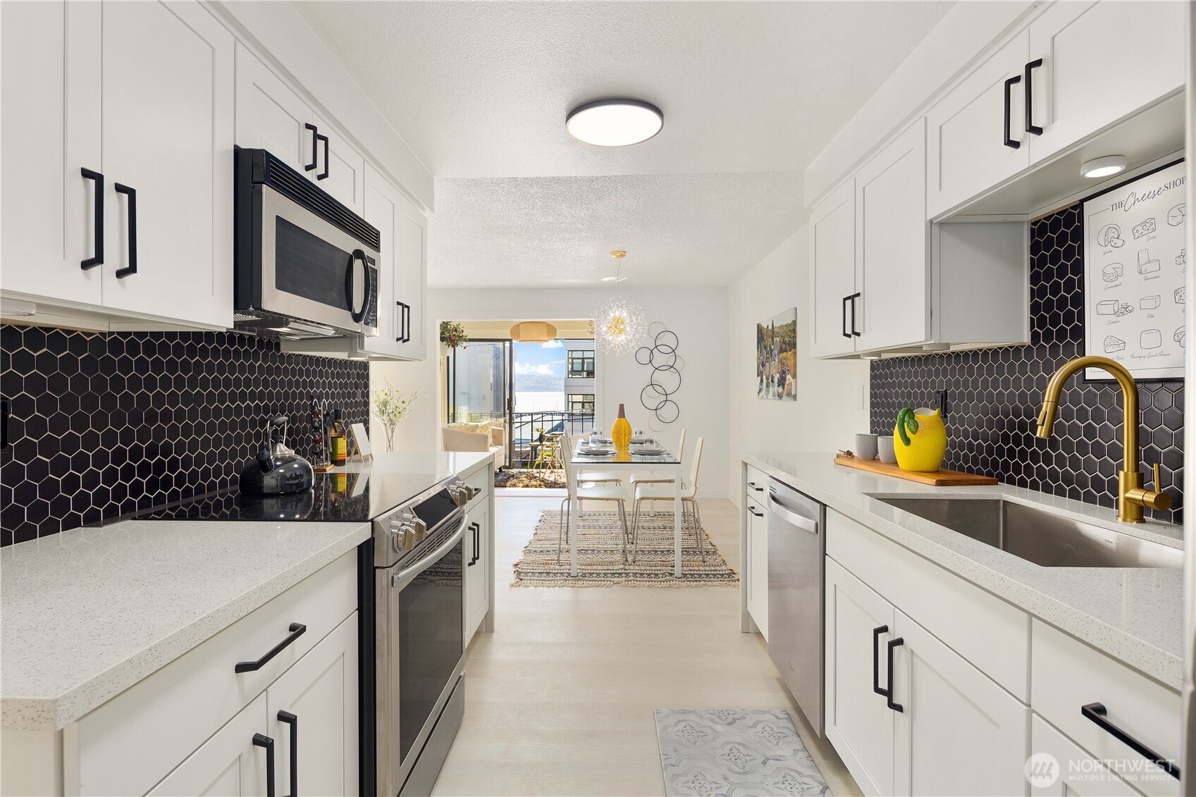 22532 6th Avenue South, Unit A2 Seattle, WA 98198 - Photo 10 of 35 a kitchen with a sink stove and cabinets