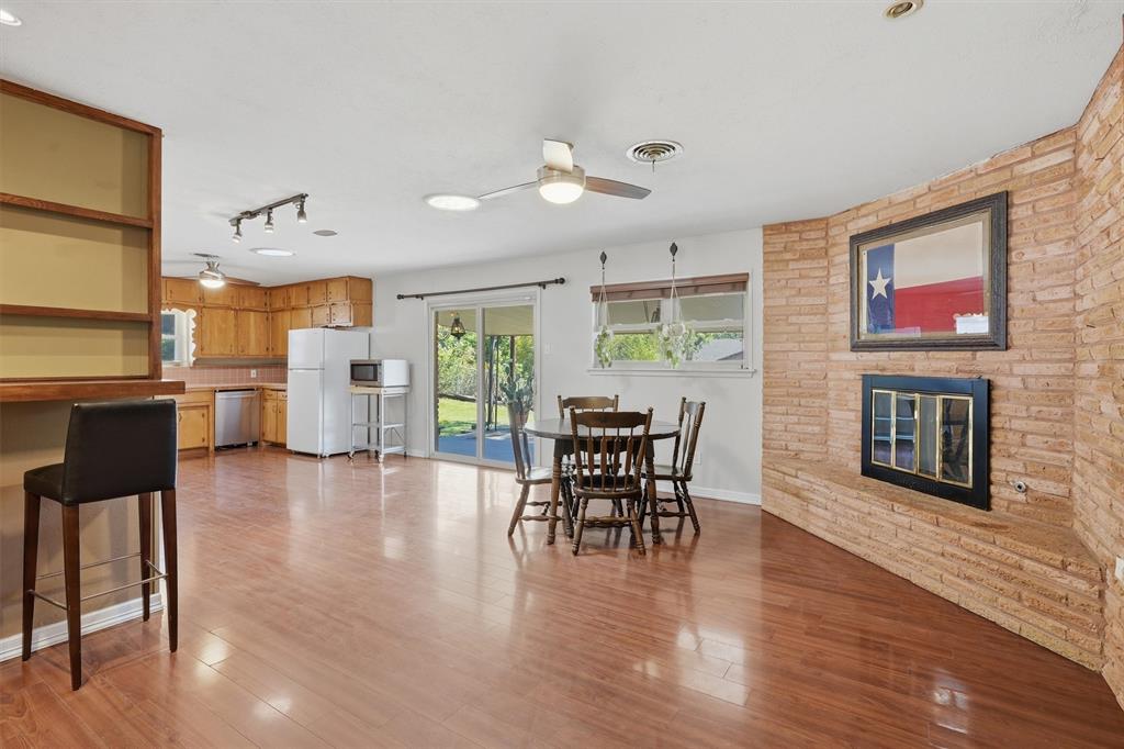 4105 Springbranch Drive Benbrook, TX 76116 - Photo 9 of 30 a view of a dining room with furniture window and wooden floor