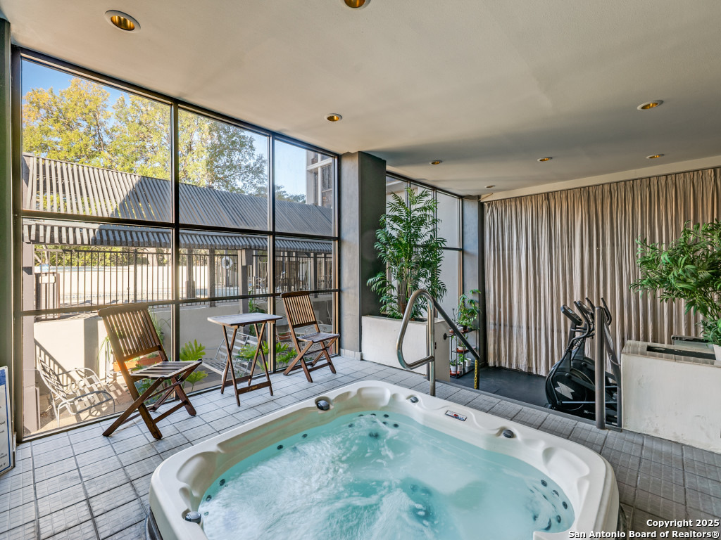7701 Wurzbach Road, Unit 807 San Antonio, TX 78229 - Photo 15 of 20 a living room with furniture and a floor to ceiling window
