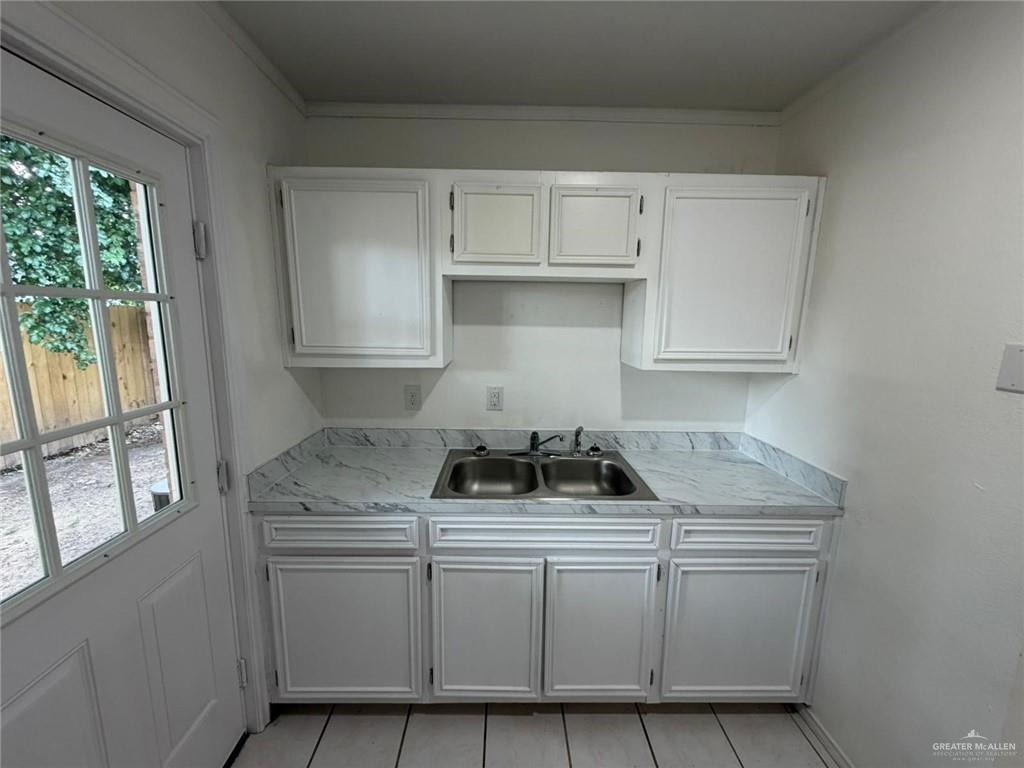 2612 West Mile 17 1/2 Road, Unit 12 Edinburg, TX 78541 - Photo 5 of 10 Dedicated laundry area featuring upper white cabinetry