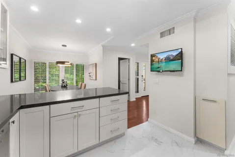 a hall with cabinets and window