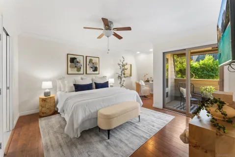 a spacious bedroom with a bed and wooden floor