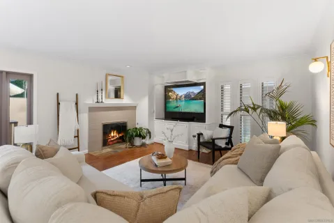 a living room with furniture fireplace and a flat screen tv