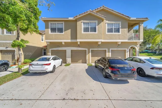 a car parked in front of a white house