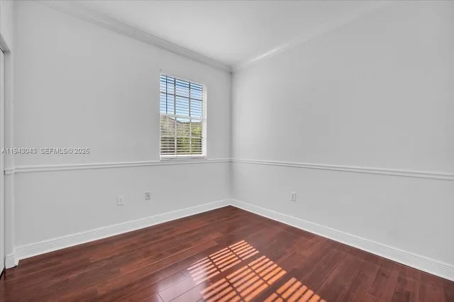 a view of a room with wooden floor and windows