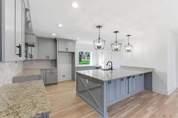 a kitchen with granite countertop white cabinets white stainless steel appliances with a sink and dishwasher