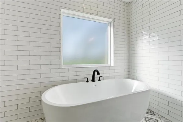 a bathroom with a granite countertop toilet sink and mirror