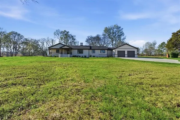 a big house with a big yard and large trees