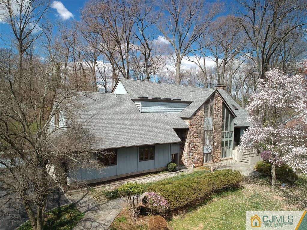 77 Buchanan Road Edison, NJ 08820 - Photo 22 of 25 a front view of house with yard and trees in the background