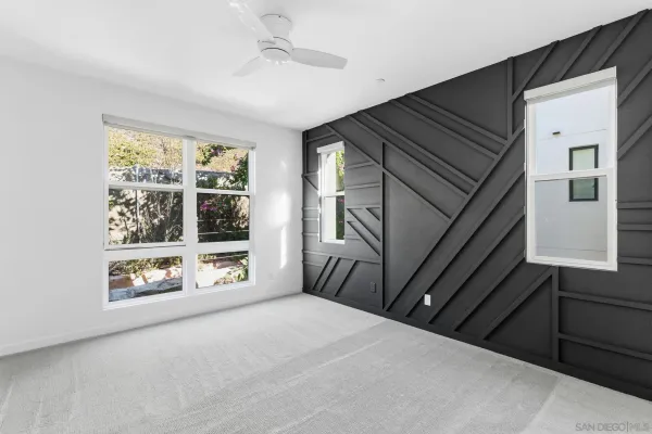 a living room with a fireplace and a large window