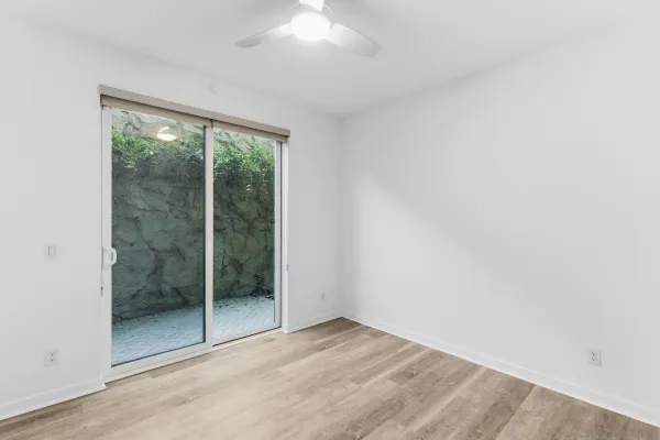 a view of an empty room with glass door