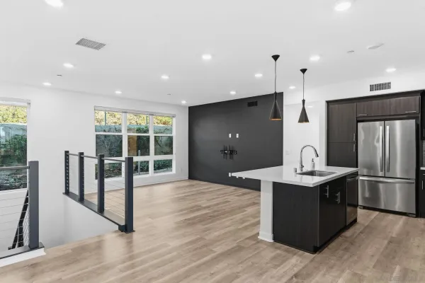 a kitchen with stainless steel appliances granite countertop a sink refrigerator and microwave