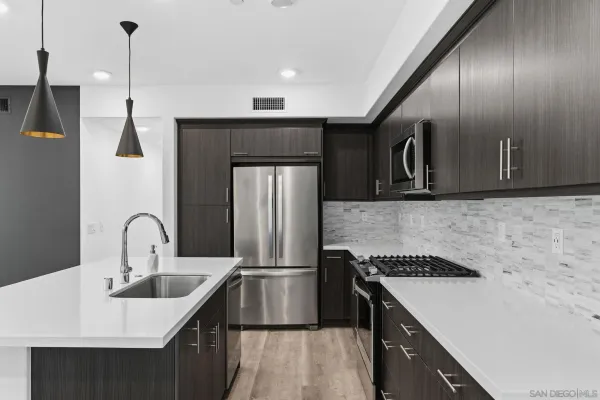 a kitchen with a sink a stove and a refrigerator