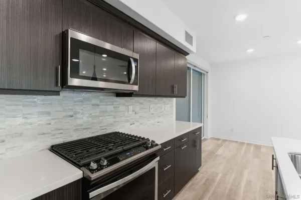 a stove top oven sitting inside of a kitchen