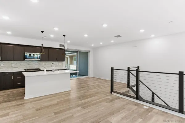 a kitchen with stainless steel appliances kitchen island granite countertop a stove a sink and a refrigerator