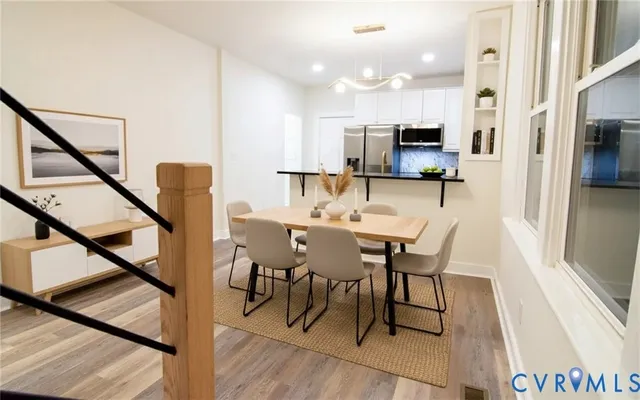 a view of a dining room with furniture and a wooden floor
