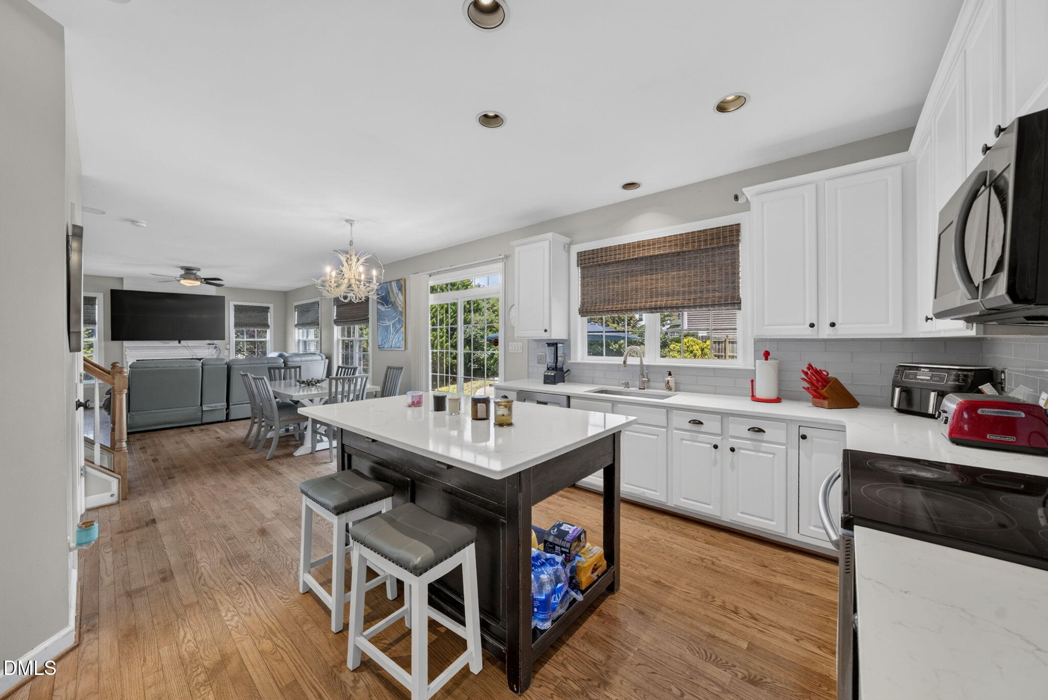 1258 Horsham Way Apex, NC 27502 - Photo 11 of 32 a kitchen with wooden cabinets and center island