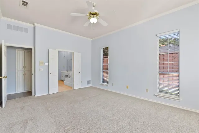 a view of empty room with ceiling fan