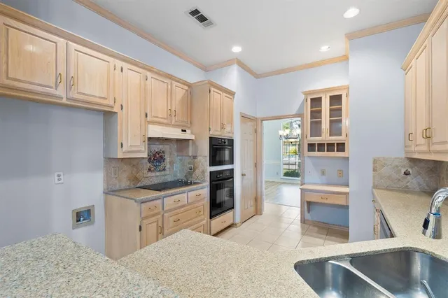 a kitchen with stainless steel appliances granite countertop a refrigerator sink and cabinets