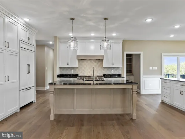 a view of a closet with wooden floor
