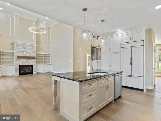 a kitchen with stainless steel appliances granite countertop a stove a sink a refrigerator and a granite counter tops