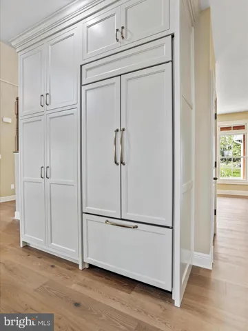 a view of a balcony with wooden floor and floor to ceiling window