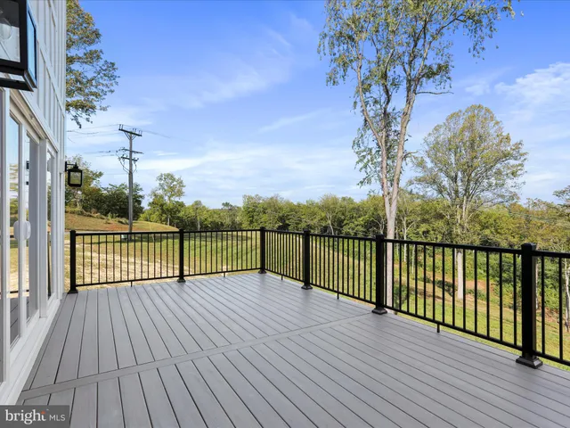 an empty room with wooden floor and a ceiling fan