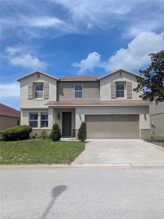 149 Roseling Crossing Davenport, FL 33897 - Photo 1 of 1 a front view of a house with a garden