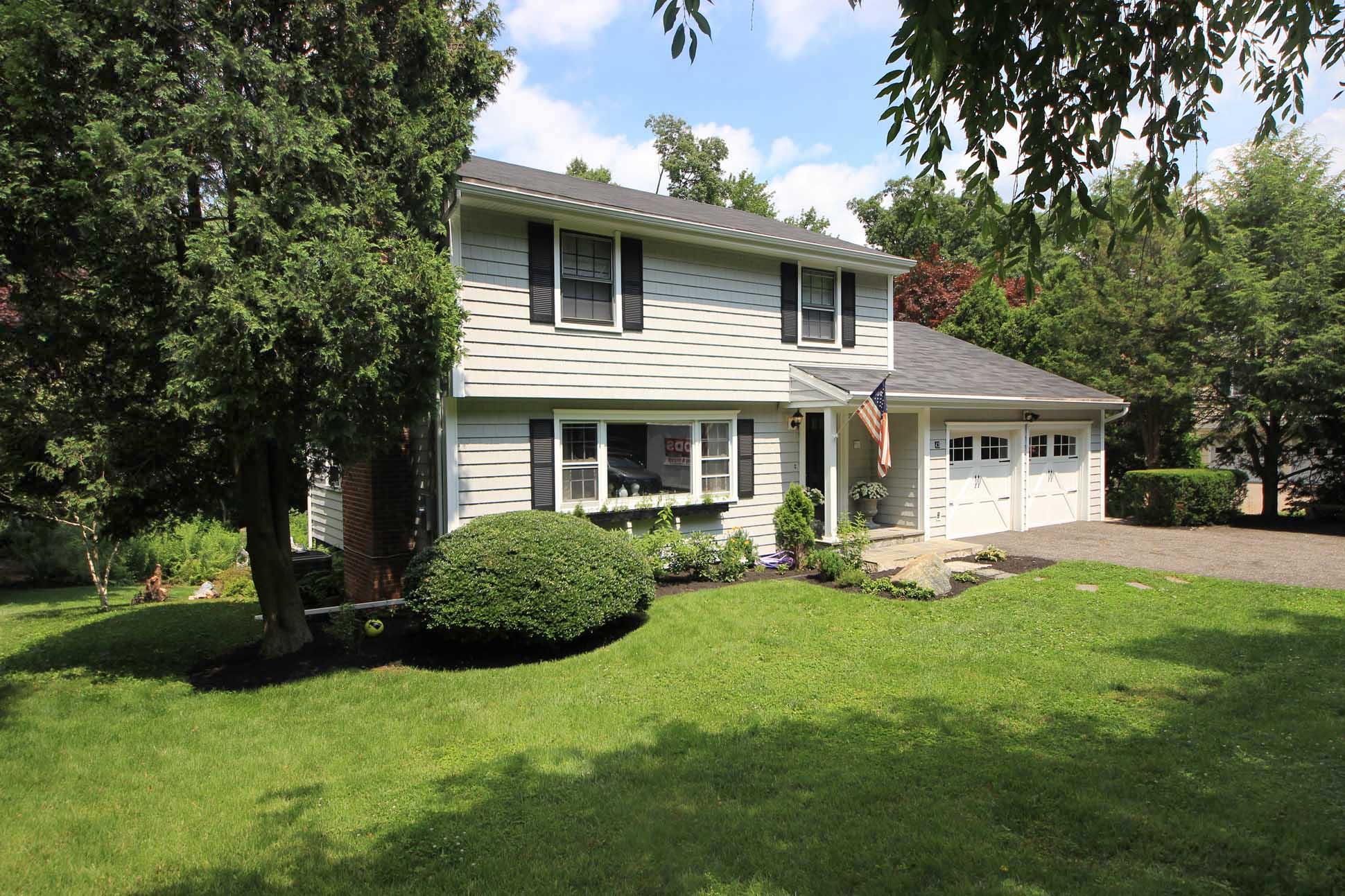 43 Rural Drive New Canaan, CT 06840 - Photo 1 of 26 a front view of a house with a yard and trees