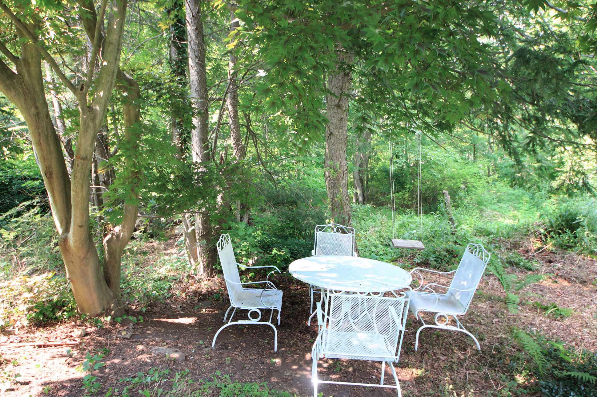 43 Rural Drive New Canaan, CT 06840 - Photo 22 of 26 a view of a table and chairs in back yard