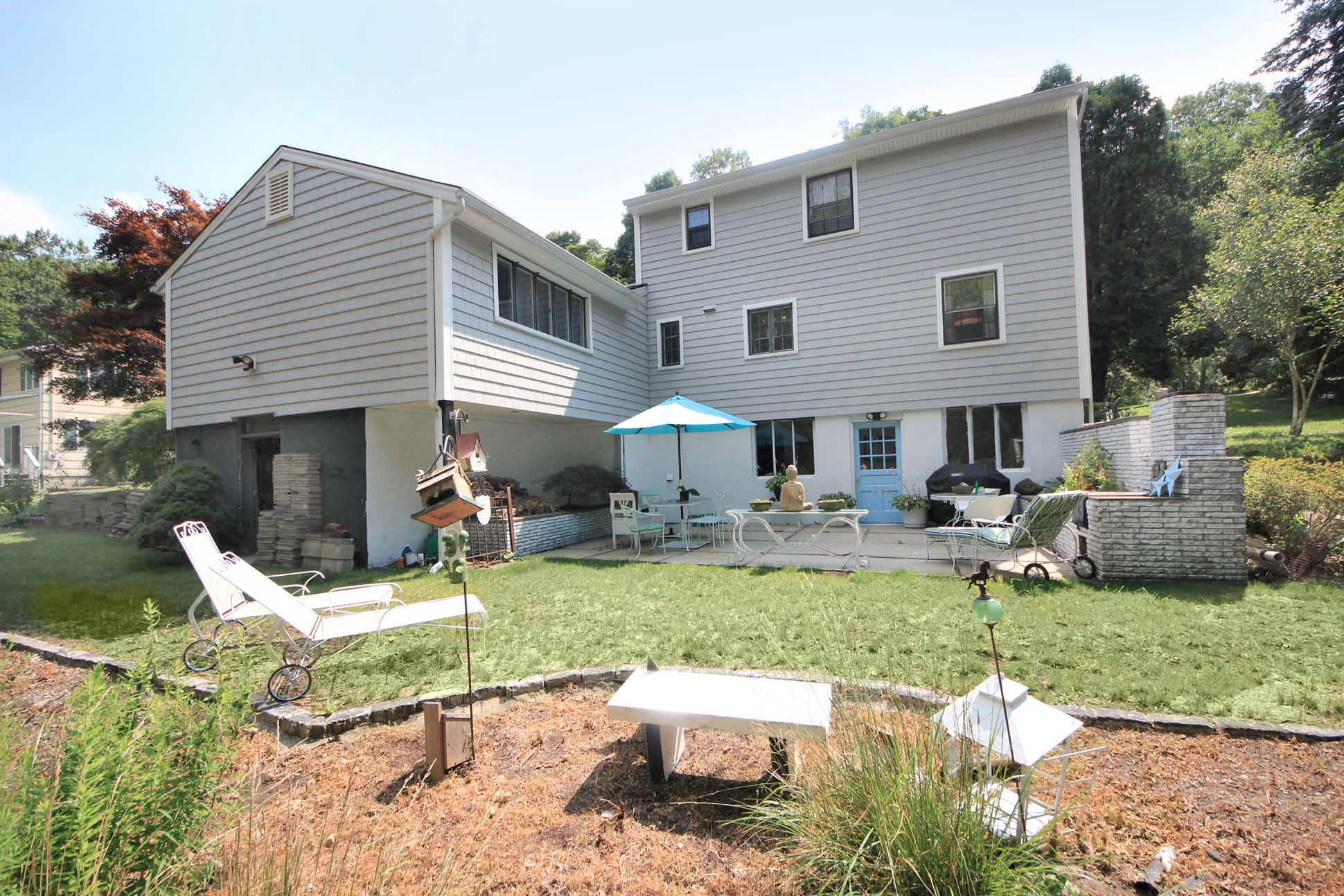 43 Rural Drive New Canaan, CT 06840 - Photo 24 of 26 a view of a house with backyard sitting area and swimming pool
