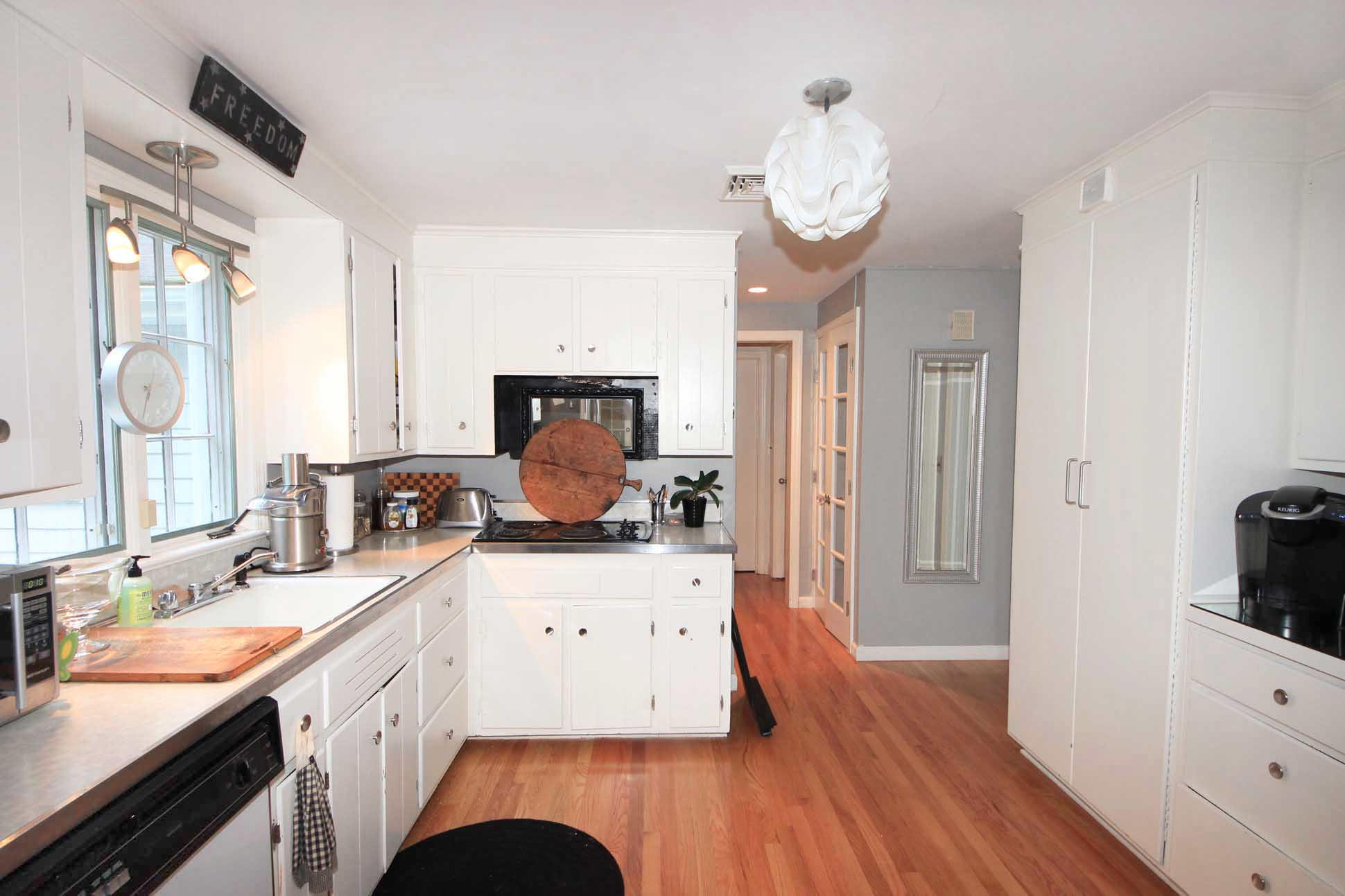 43 Rural Drive New Canaan, CT 06840 - Photo 10 of 26 a open kitchen with a sink dishwasher a dining table and chairs with wooden floor