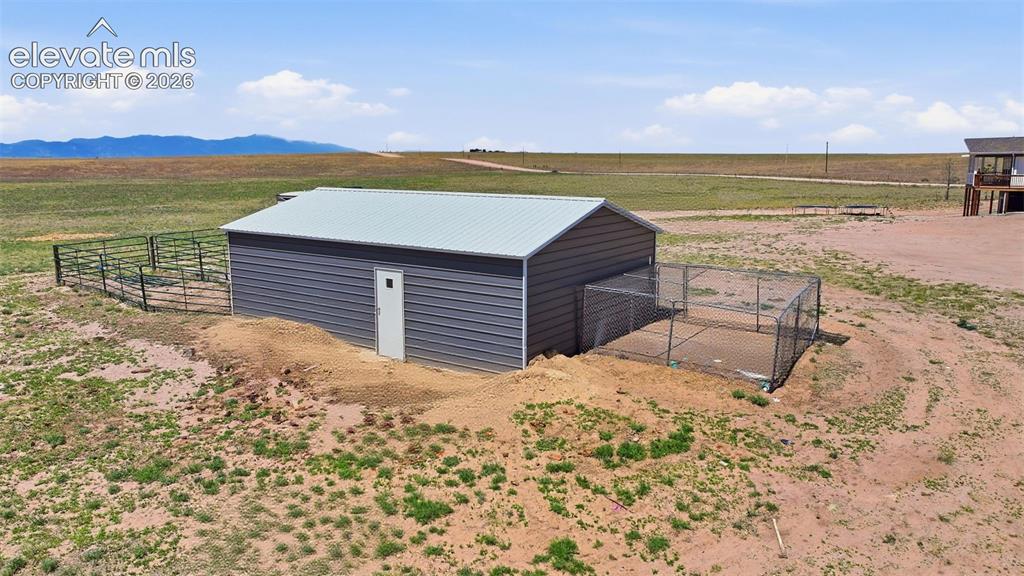 23335 Sanborn Road Calhan, CO 80808 - Photo 12 of 28 Additional view of metal building, livestock pens, and fenced acreage