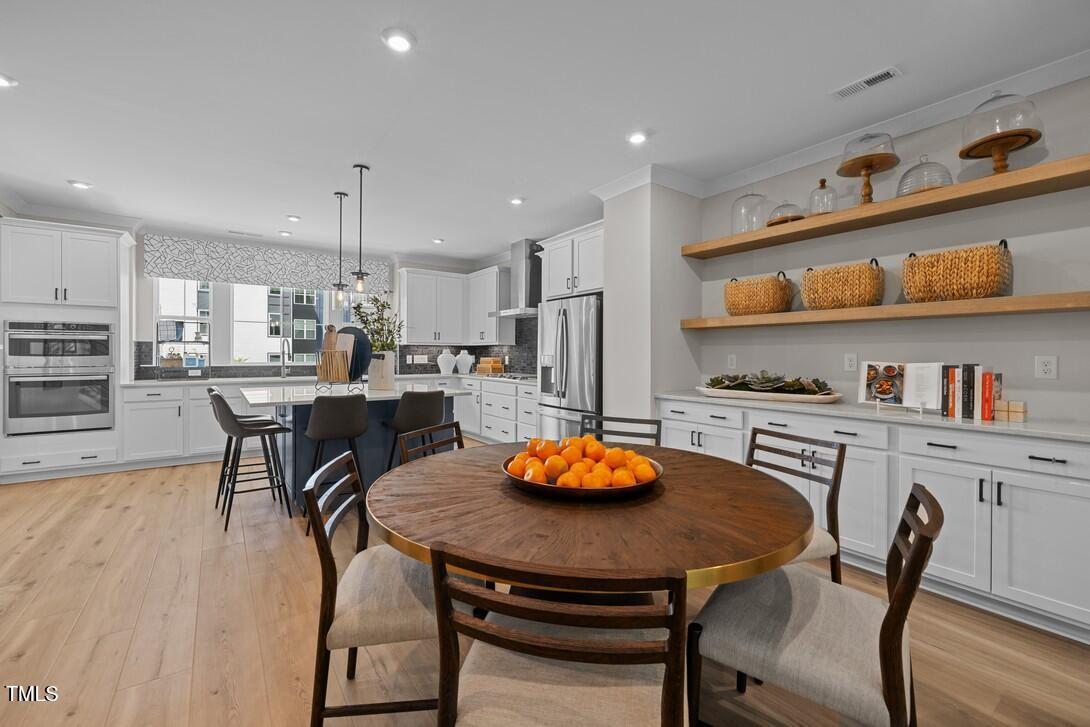 4504 Mint Leaf Lane Raleigh, NC 27612 - Photo 14 of 42 a kitchen with a table and chairs in it