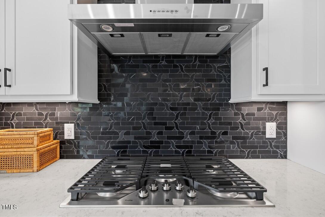4504 Mint Leaf Lane Raleigh, NC 27612 - Photo 21 of 42 a kitchen with a stove and cabinets