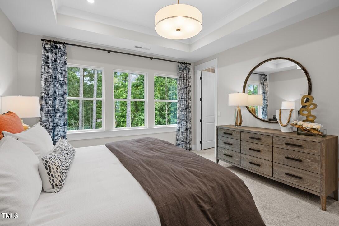 4504 Mint Leaf Lane Raleigh, NC 27612 - Photo 35 of 42 a bedroom with a bed and a dresser